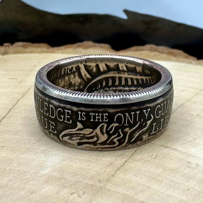 U.S. 2026 Half Dollar Coin Ring on a light wood round with a metal mountain background. - Mountainstruck Coin Jewelry