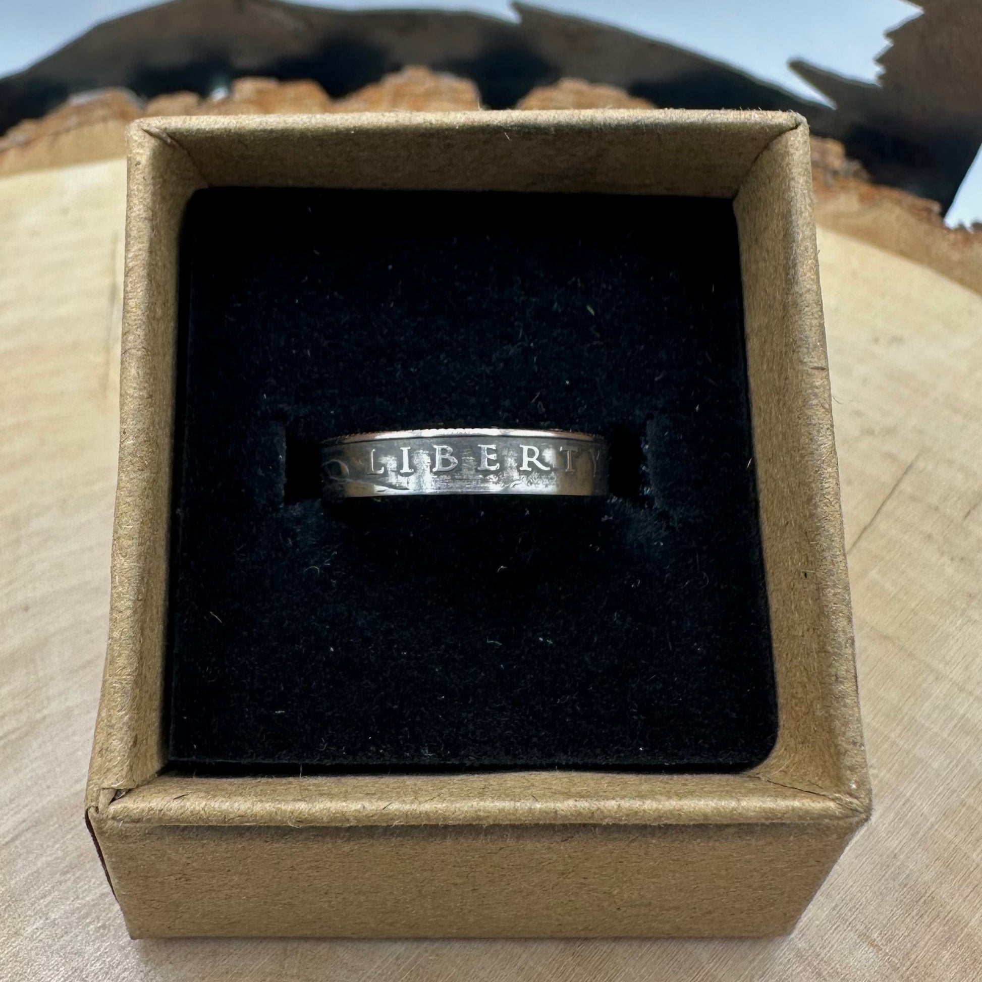 U.S. 2026 "Emerging Liberty" Dime Coin Ring on a black velvet background in a brown kraft box on a wood round. - Mountainstruck Coin Jewelry