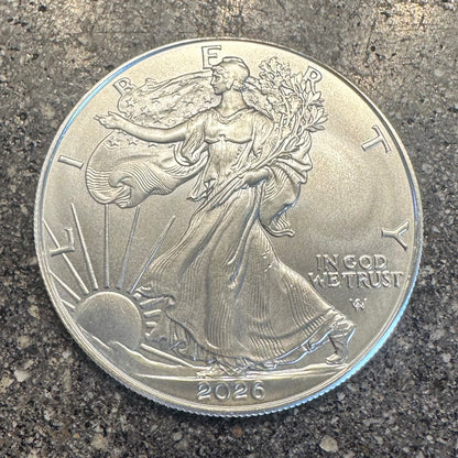 U.S. 2026 1oz 999 Silver Eagle $1 Coin on a concrete background. - Mountainstruck Coin Jewelry