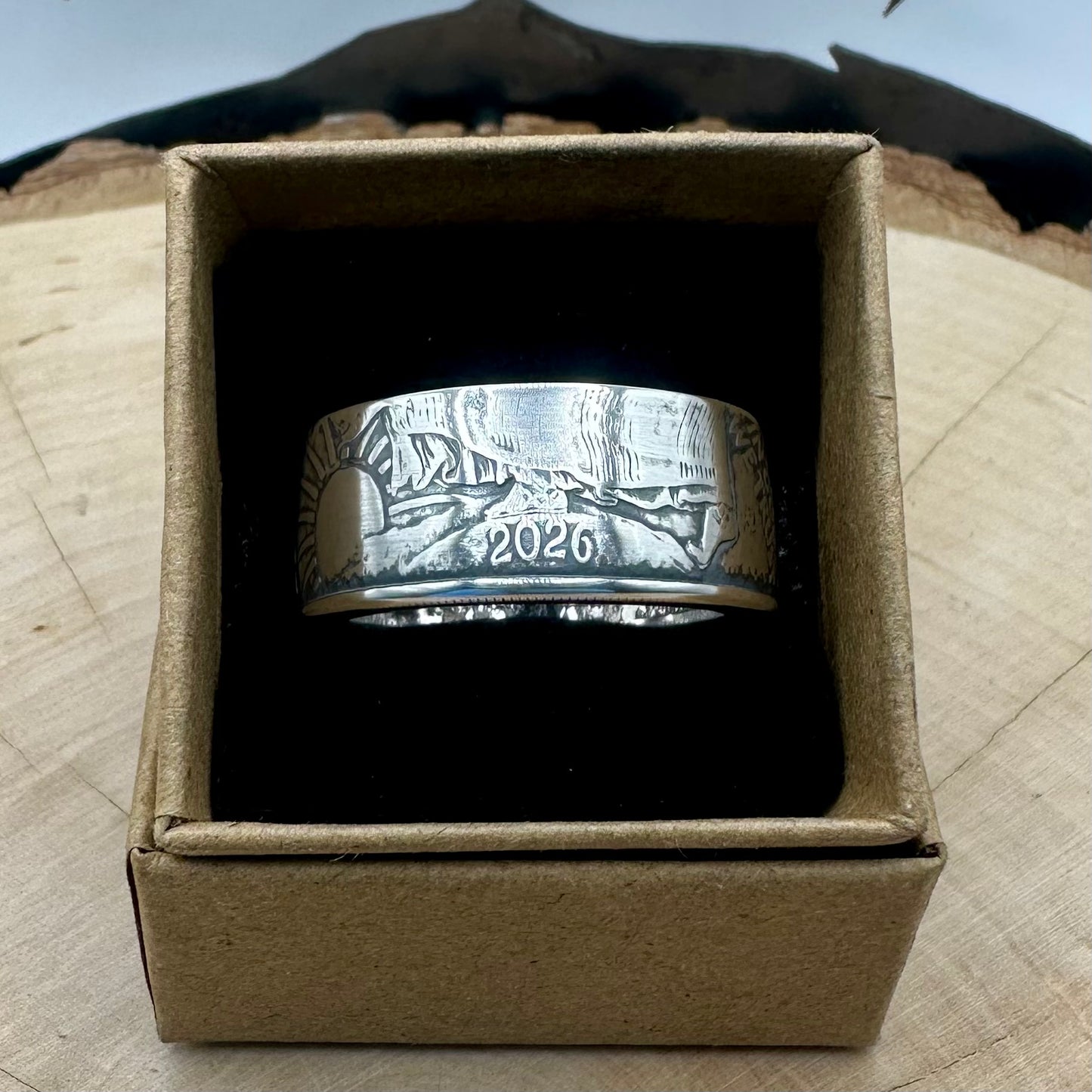 U.S. 2026 1oz 999 Silver Eagle $1 Coin Ring on a black velvet background in a brown kraft box on a wood round. - Mountainstruck Coin Jewelry