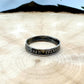 U.S. Dime Silver Coin Ring patina on a light wood round with a metal mountain background. - Mountainstruck Coin Jewelry