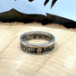 U.S. Standing Liberty Quarter Silver Coin Ring ion a light wood round with a metal mountain background. - Mountainstruck Coin Jewelry