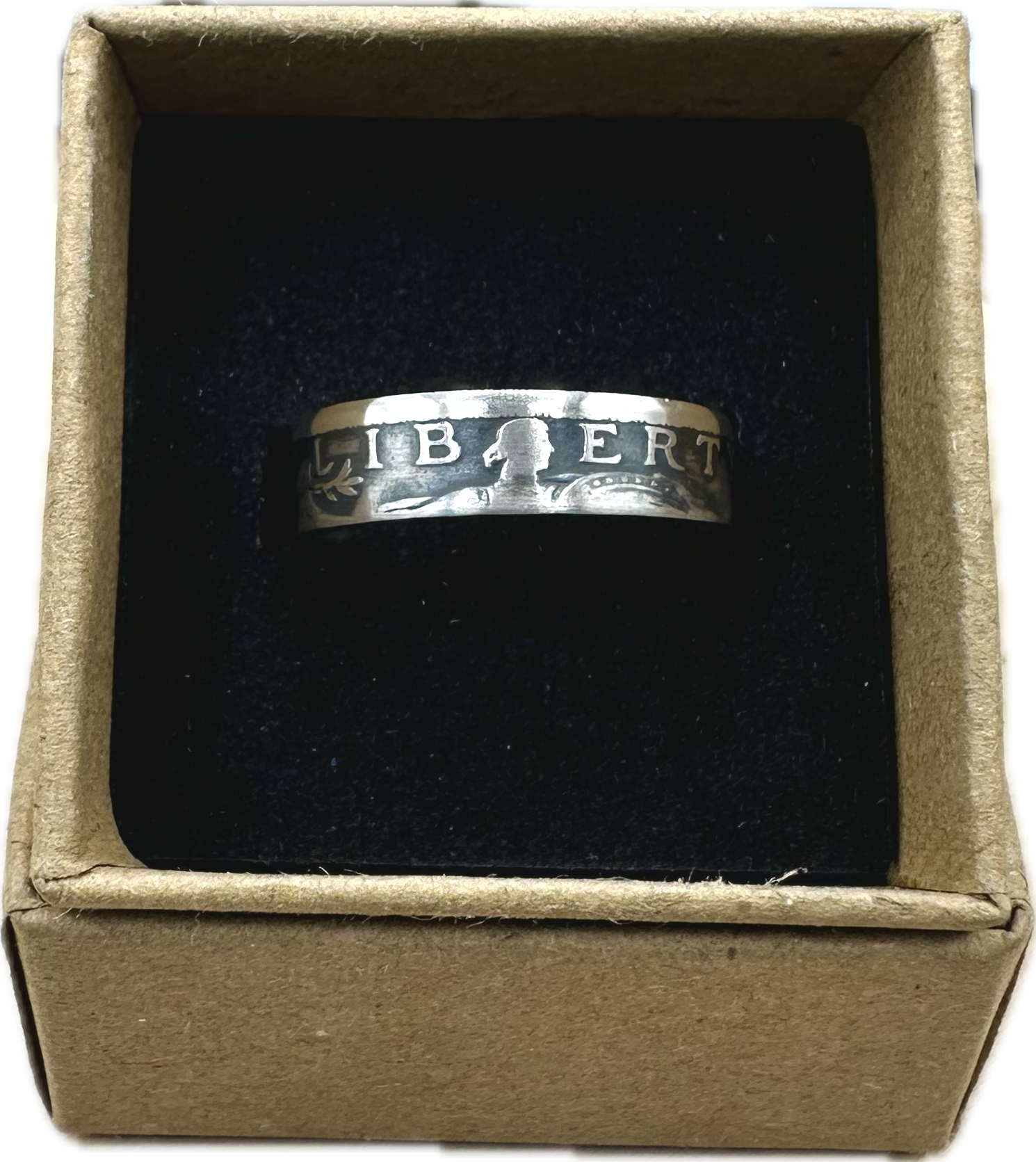 U.S. Standing Liberty Quarter Silver Coin Ring in a brown kraft box on a black velvet background. - Mountainstruck Coin Jewelry