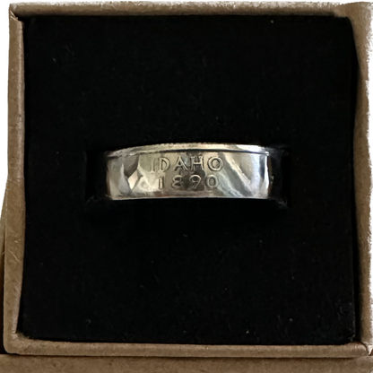 U.S. State Quarter Coin Ring featuring Idaho shined in a brown kraft box on a black velvet background. - Mountainstruck Coin Jewelry