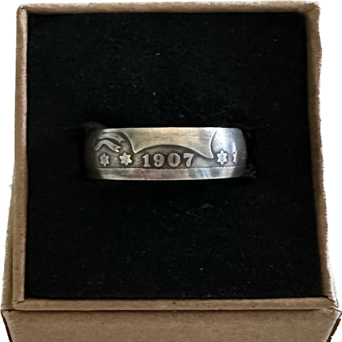 U.S. Barber Silver Quarter Coin Ring (front) on a black velvet background in a brown kraft box. 
- Mountainstruck Coin Jewelry