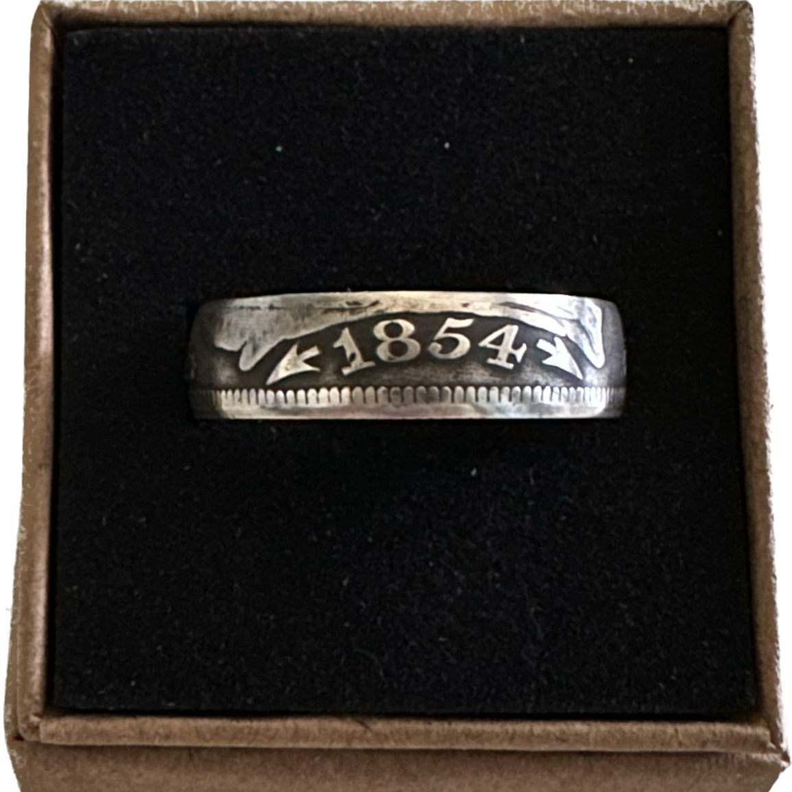 U.S. Seated Liberty Quarter Silver Coin Ring in a black velvet background in a brown kraft box. 
- Mountainstruck Coin Jewelry