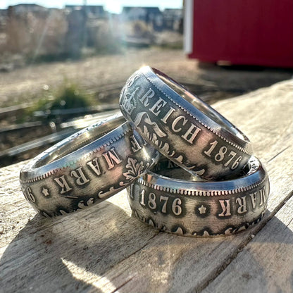 Three German silver coin rings with 'Reich 1876' text on a wooden surface. - Mountainstruck Coin Jewelry