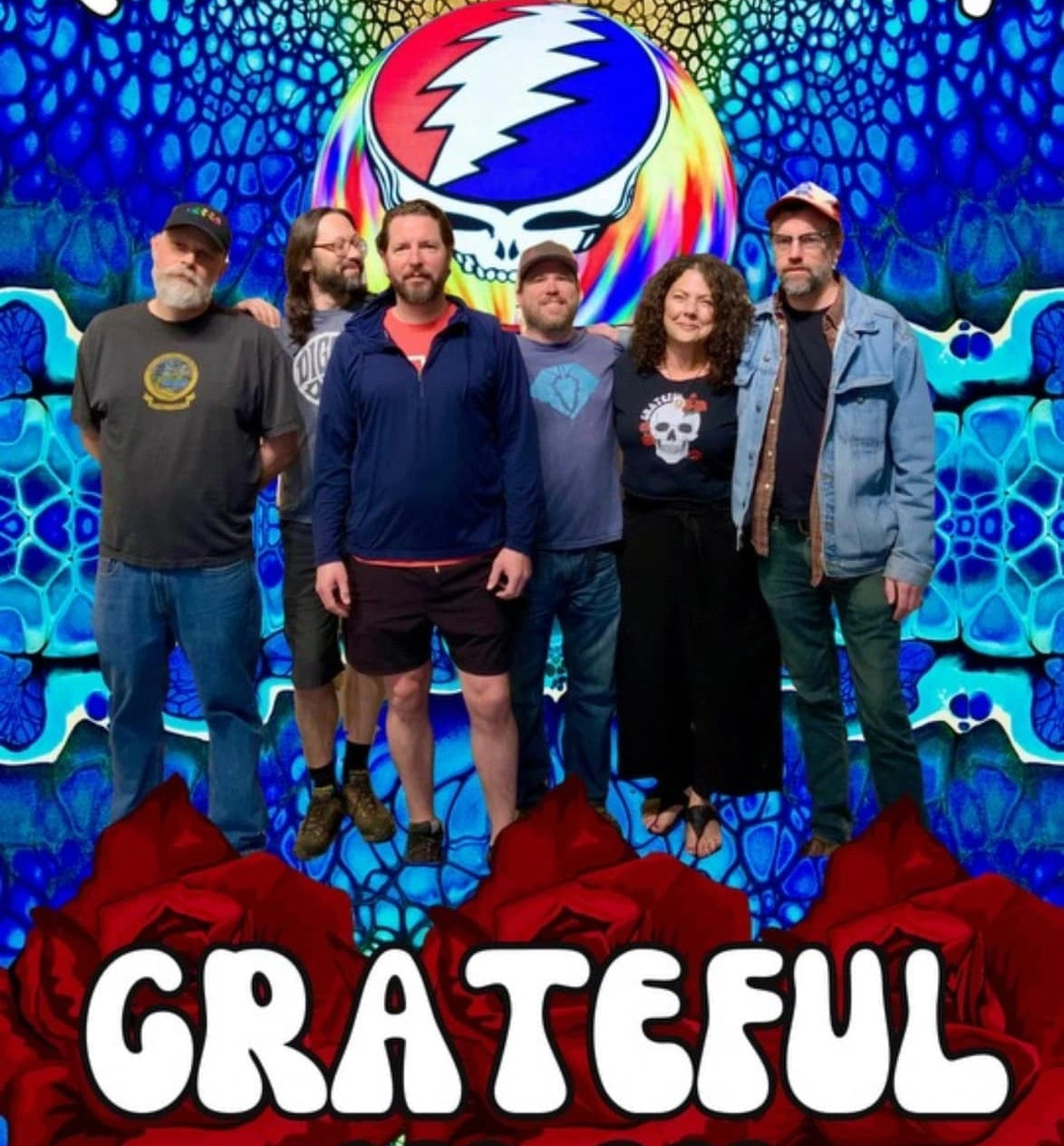 Grateful Band standing in front of a Grateful Dead logo. - Mountainstruck Coin Jewelry