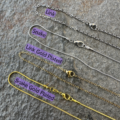 Link chain, snake chain, gold plated link chain, and gold plated snake chains set on a gray stone surface with black text and light purple background for each type of chain. 
- Mountainstruck Coin Jewelry