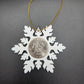 2025 Half Dollar Christmas Ornament  with an uncirculated half dollar cased inside a white 3D printed snowflake with golden tassel on a black background. - Mountainstruck Coin Jewelry