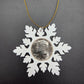 2025 Half Dollar Christmas Ornament  with an uncirculated half dollar cased inside a white 3D printed snowflake with golden tassel on a black background. - Mountainstruck Coin Jewelry