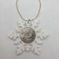 2025 Half Dollar Christmas Ornament  with an uncirculated half dollar cased inside a white 3D printed snowflake with golden tassel on a white background. - Mountainstruck Coin Jewelry