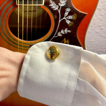24k Gold Plate U.S. Wheat Penny Coin Cufflinks in a white button up shirt sleeve in front of an acoustic guitar.  - Mountainstruck Coin Jewelry