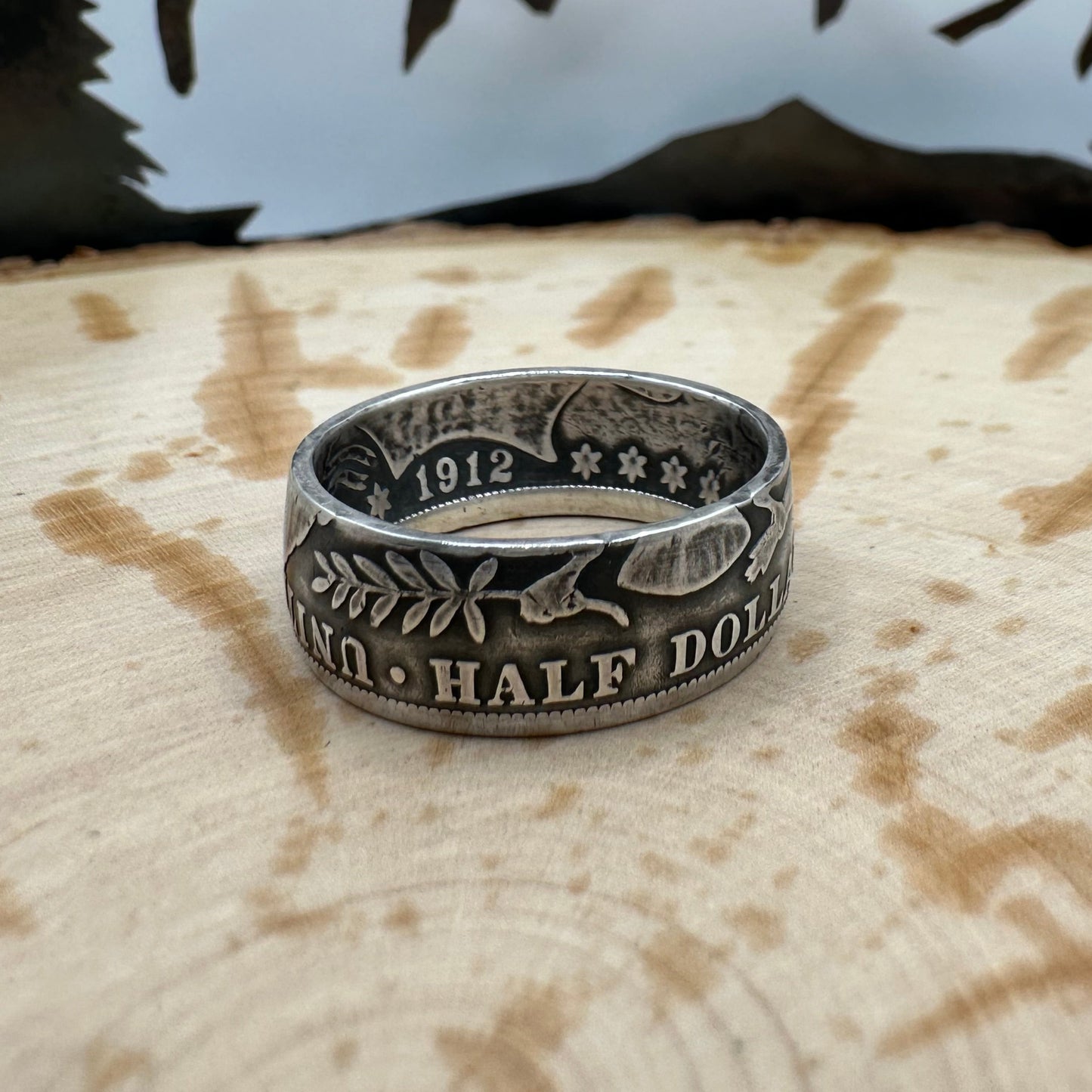 Barber Half Dollar Silver Coin Ring (reverse) on a wood background. - Mountainstruck Coin Jewelry