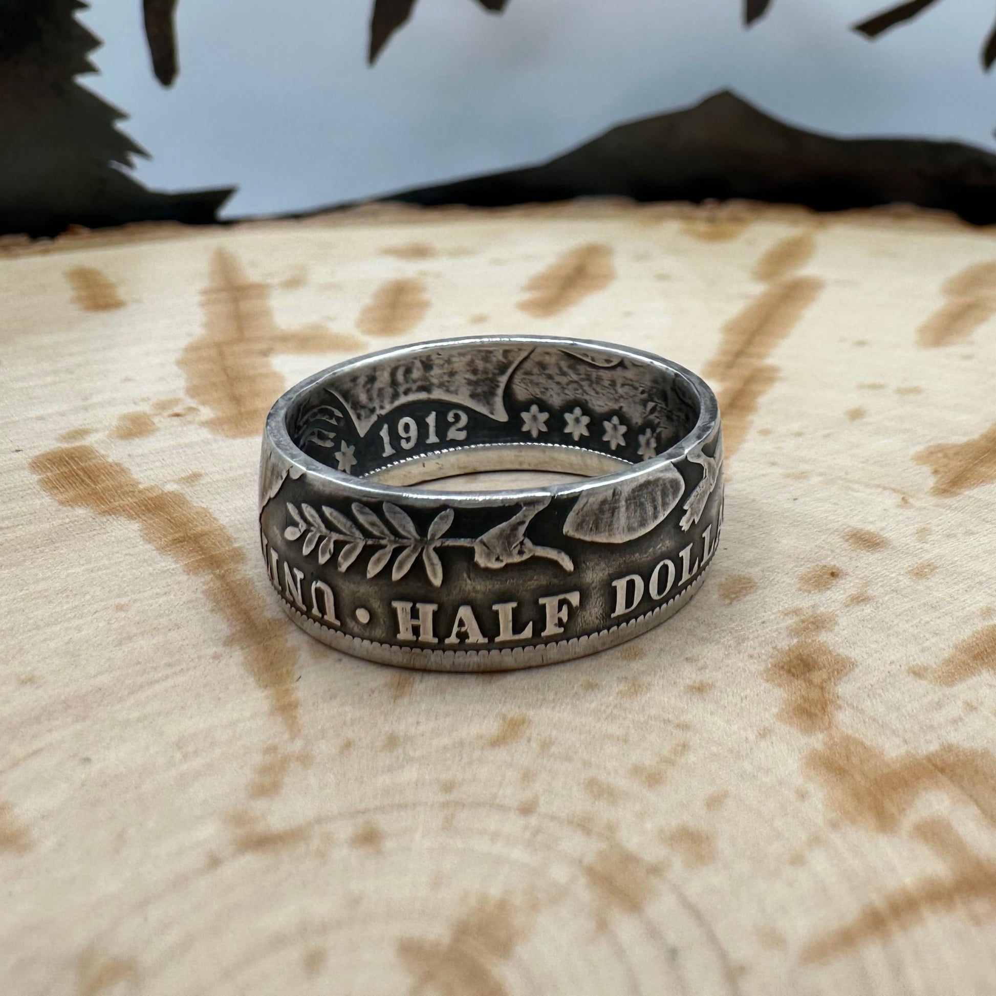 Barber Half Dollar Silver Coin Ring (reverse) on a wood background. - Mountainstruck Coin Jewelry