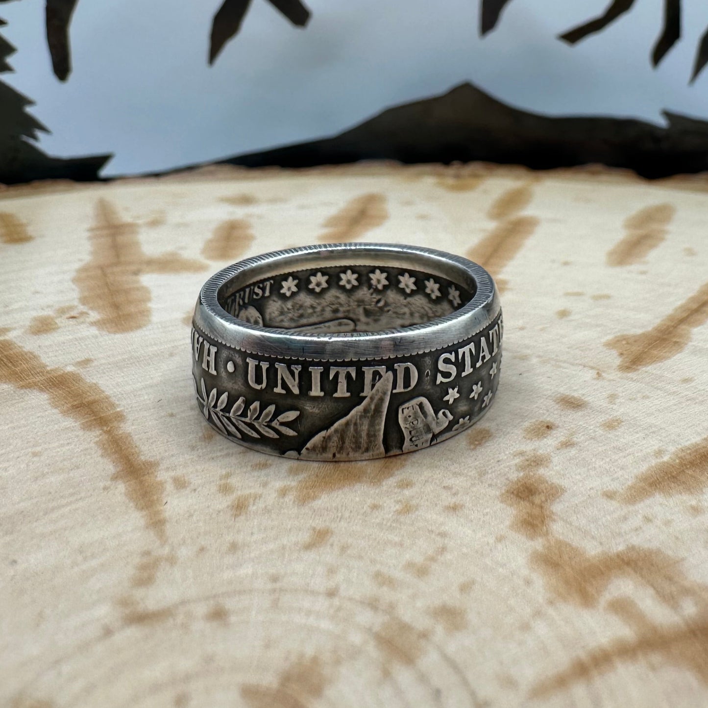 Barber Half Dollar Silver Coin Ring (reverse) on a wood background. - Mountainstruck Coin Jewelry