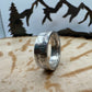 Ben Franklin Half Dollar Silver Coin Ring on a light wood round with a metal mountain and tree background. - Mountainstruck Coin Jewelry