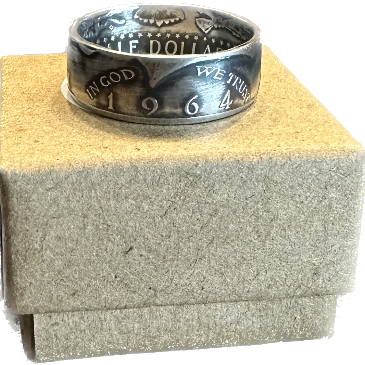 JFK 1964 Half Dollar Silver Coin on a brown kraft box. - Mountainstruck Coin Jewelry