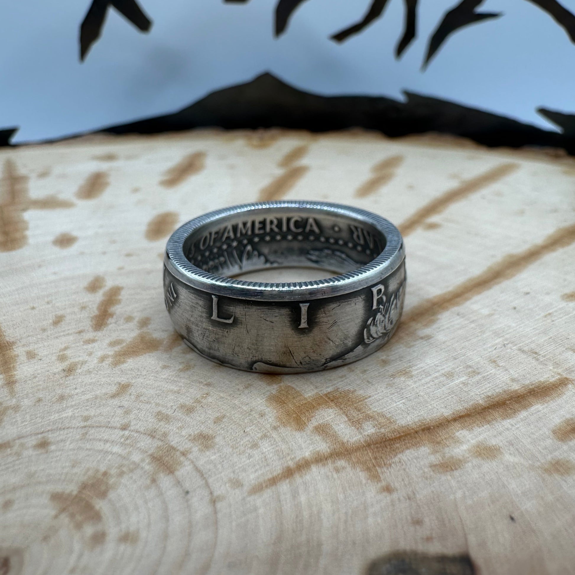 JFK 1964 Half Dollar Silver Coin Ring on a wood background. - Mountainstruck Coin Jewelry