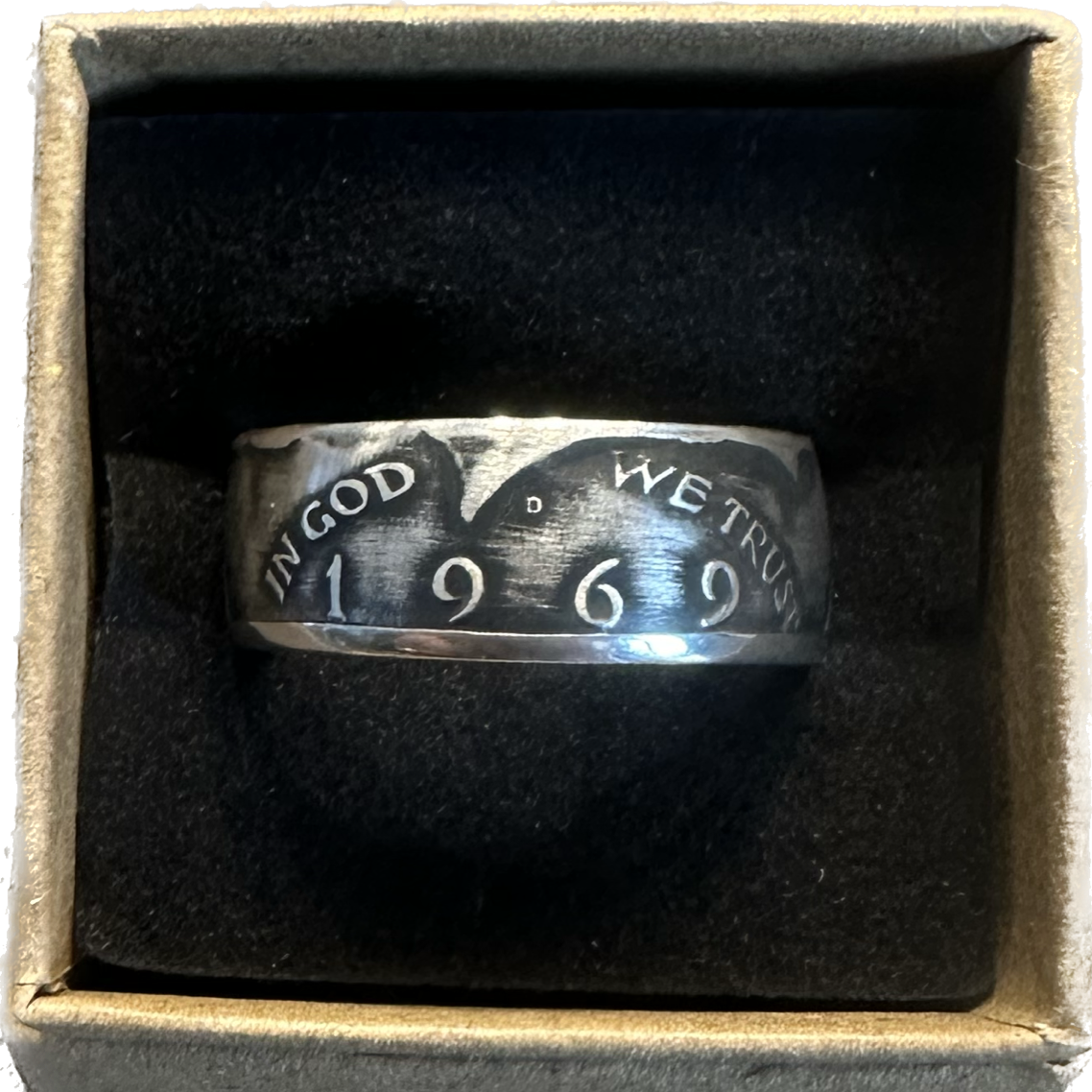 JFK Silver Half Dollar Coin Ring (front) in a brown kraft box on a black velvet background. - Mountainstruck Coin Jewelry