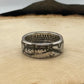 JFK Silver Half Dollar Coin Ring (front) on a light wood round with mountain outline in background. - Mountainstruck Coin Jewelry