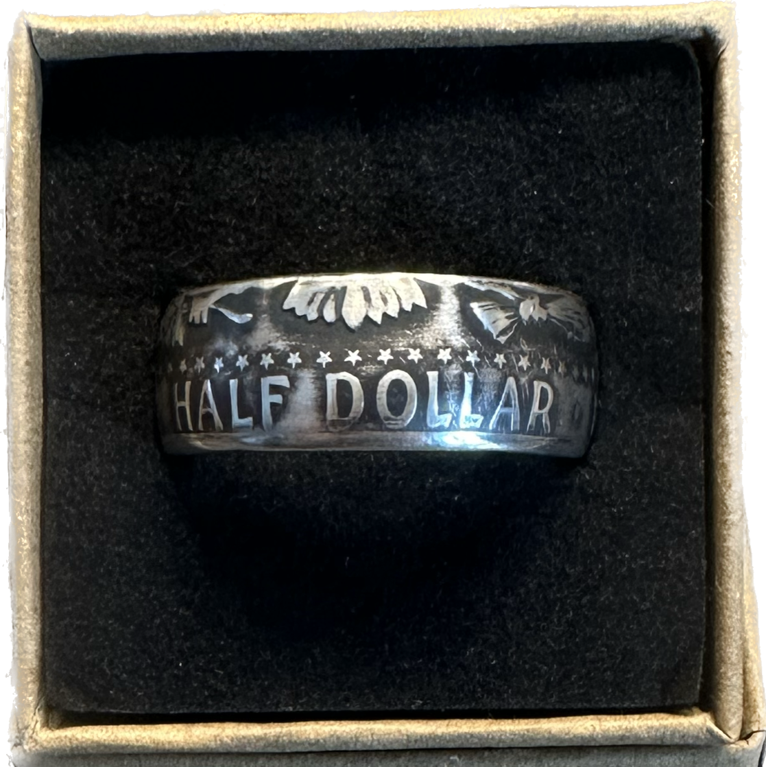 JFK Silver Half Dollar Coin Ring (reverse) in a brown kraft box on a black velvet background. - Mountainstruck Coin Jewelry