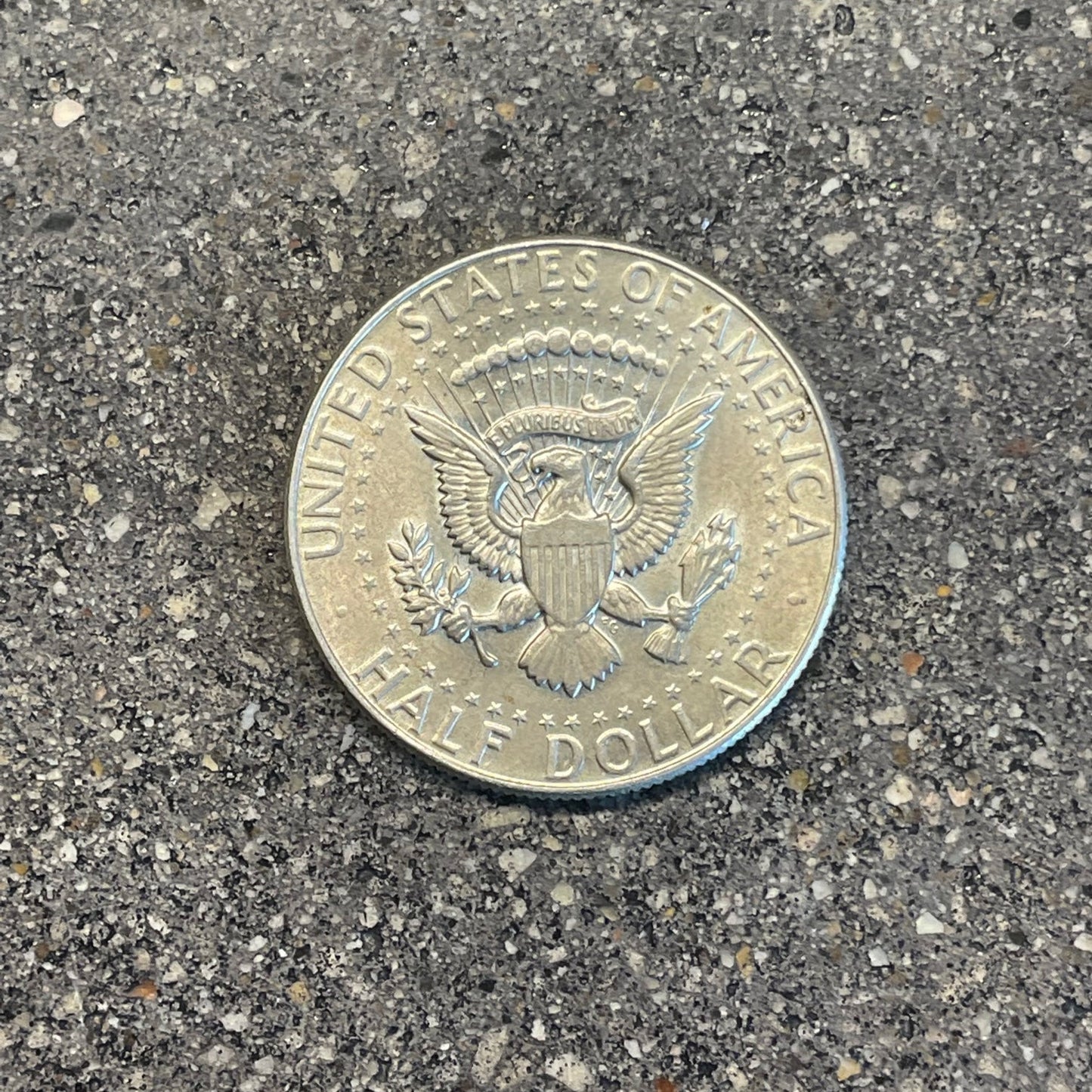 JFK Silver Half Dollar Coin (reverse) on a concrete background - Mountainstruck Coin Jewelry