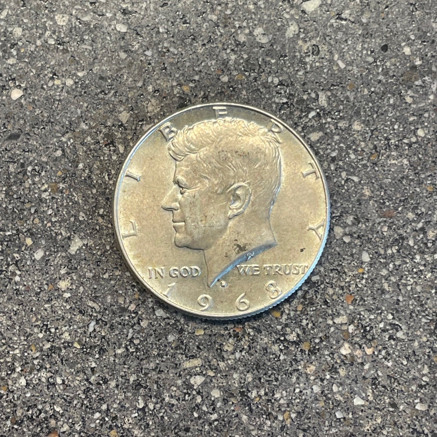 JFK Silver Half Dollar Coin front on a concrete background. - Mountainstruck Coin Jewelry