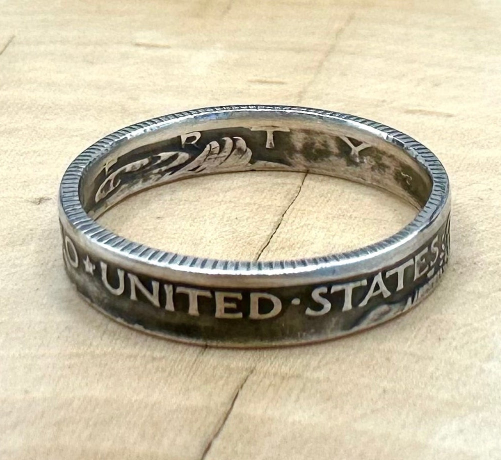 U.S. Mercury Dime Silver Coin Ring on a light wood round with metal mountains in the background. - Mountainstruck Coin Jewelry