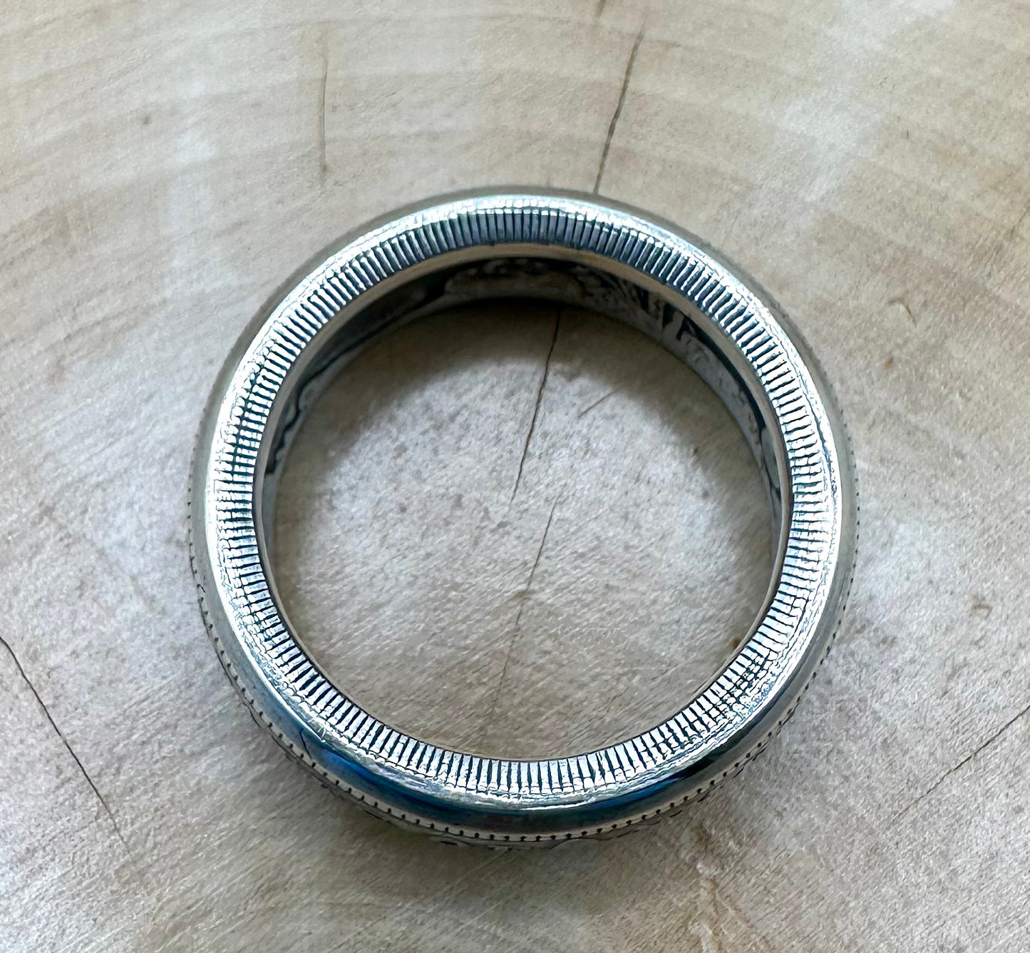 Morgan Dollar Silver Coin Ring edge on a light wood background. - Mountainstruck Coin Jewelry
