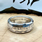 Morgan Dollar Silver Coin Ring shine on a light wood round with a metal mountain background. - Mountainstruck Coin Jewelry