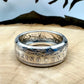 Morgan Dollar Silver Coin Ring on a light wood round with a metal mountain background. - Mountainstruck Coin Jewelry