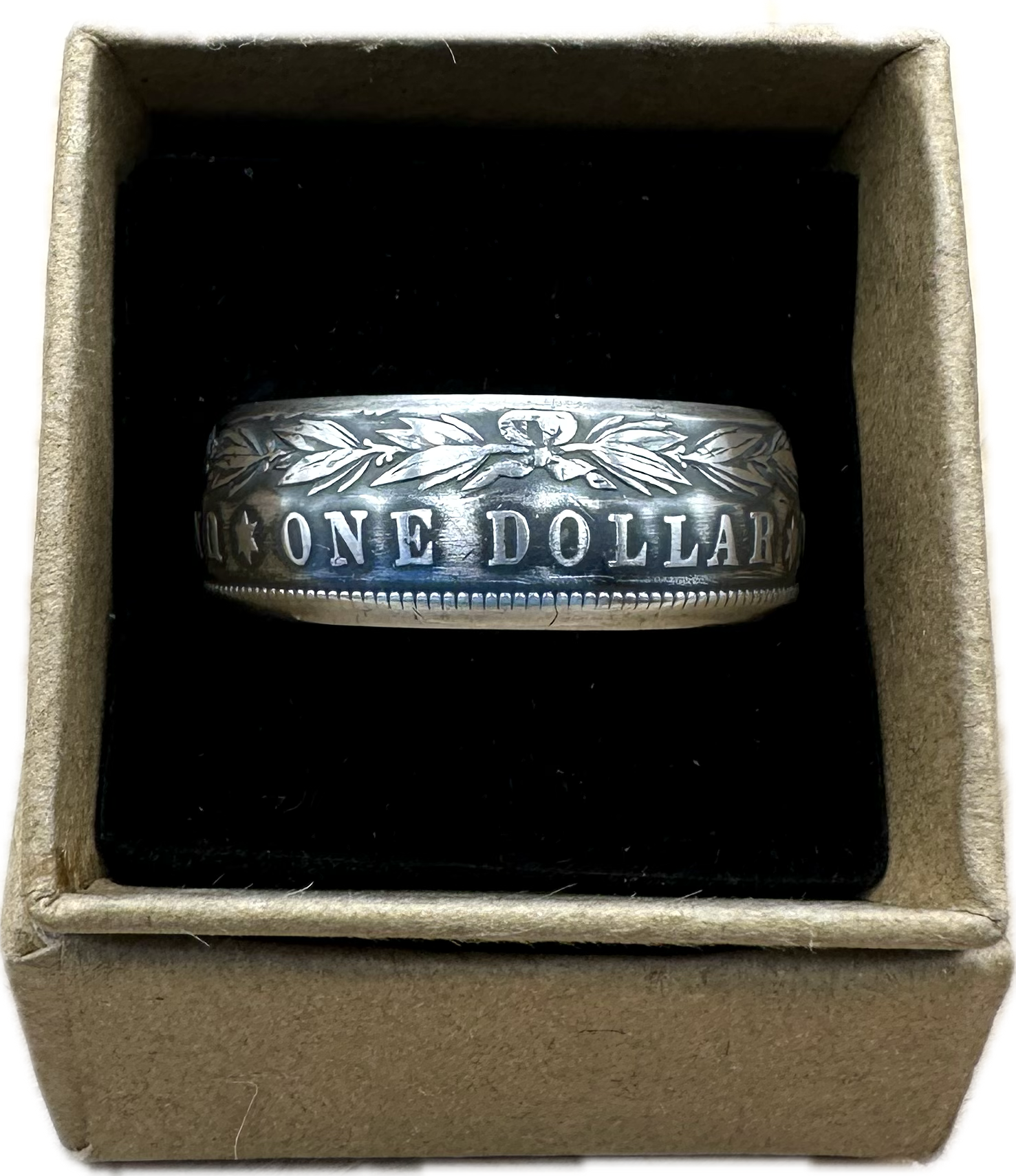 Morgan Dollar Silver Coin Ring in a brown kraft box on a black velvet background. - Mountainstruck Coin Jewelry