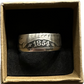 Seated Liberty Silver Half Dollar Coin Ring (patina) in a brown kraft box on a black velvet background. - Mountainstruck Coin Jewelry