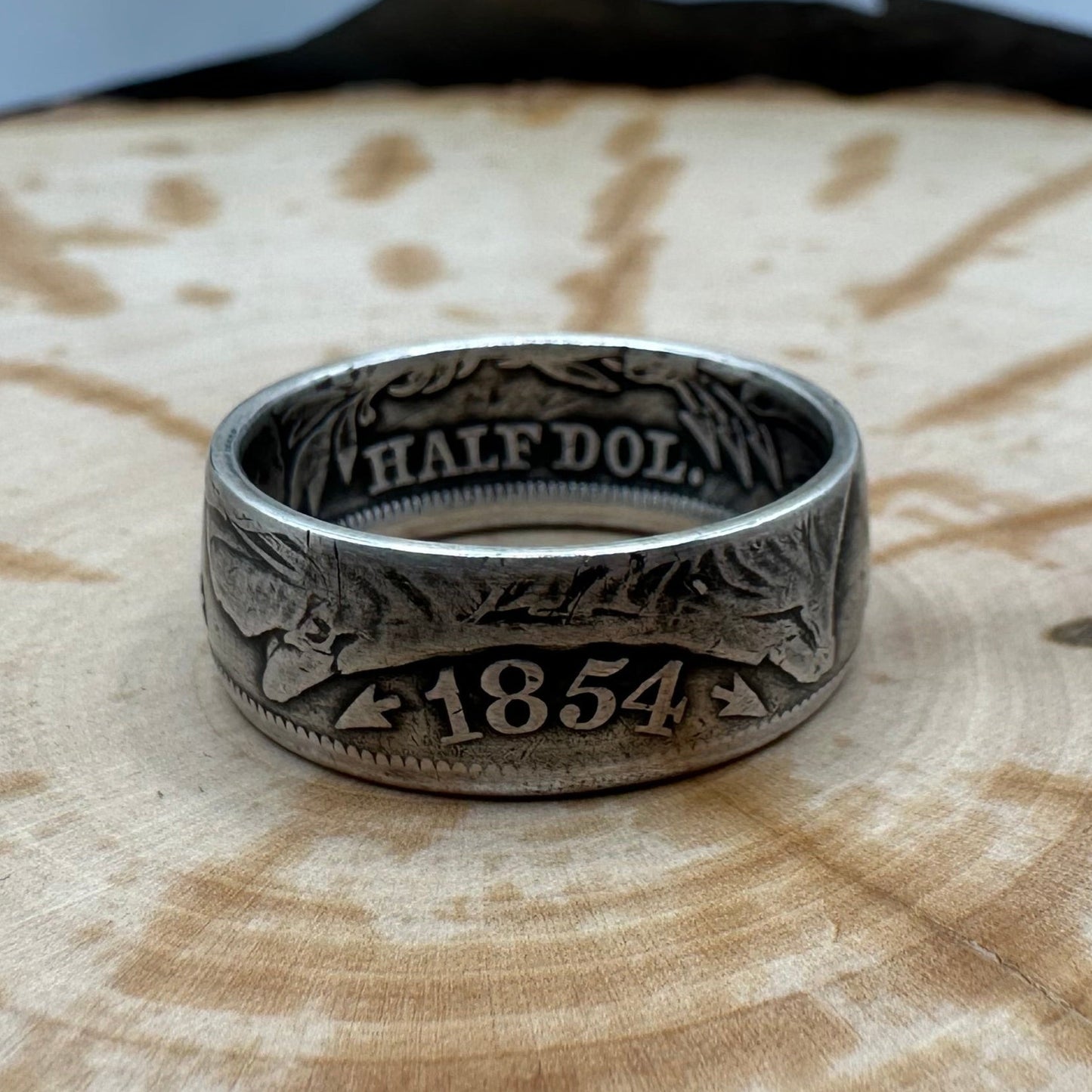 Seated Liberty Silver Half Dollar Coin Ring (patina) on a wood background. - Mountainstruck Coin Jewelry
