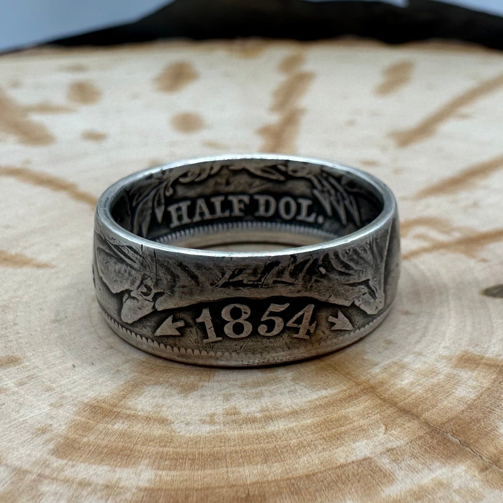 Seated Liberty Silver Half Dollar Coin Ring (patina) on a wood background. - Mountainstruck Coin Jewelry
