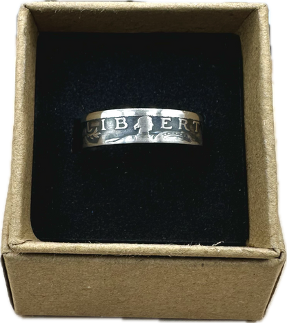U.S. Standing Liberty Quarter Silver Coin Ring in a brown kraft box on a black velvet background. - Mountainstruck Coin Jewelry