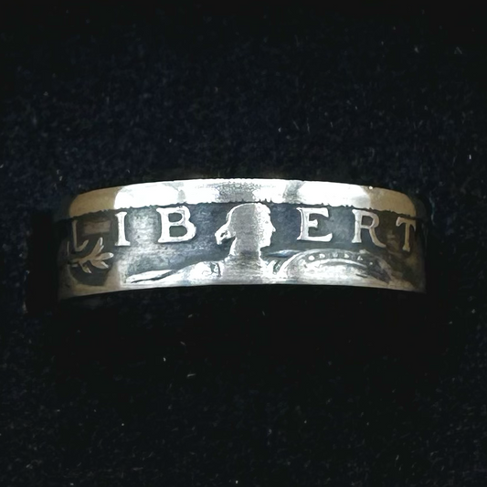 U.S. Standing Liberty Quarter Silver Coin Ring in a brown kraft box on a black velvet background. - Mountainstruck Coin Jewelry