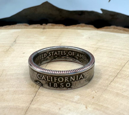 U.S. State Quarter Coin Ring featuring California on a light wood round with metal mountain background. - Mountainstruck Coin Jewelry