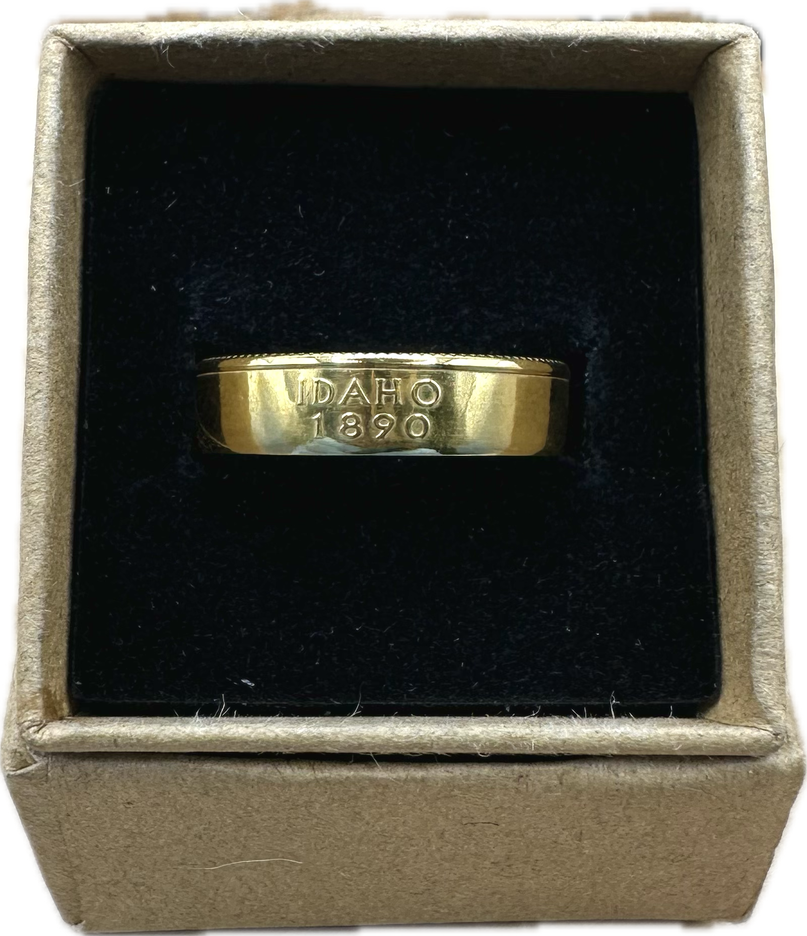 Gold Plated U.S. State Quarter Coin Ring featuring Idaho in a brown kraft box on a black velvet background. - Mountainstruck Coin Jewelry