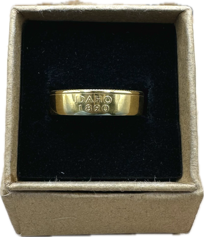 Gold Plated U.S. State Quarter Coin Ring featuring Idaho in a brown kraft box on a black velvet background. - Mountainstruck Coin Jewelry