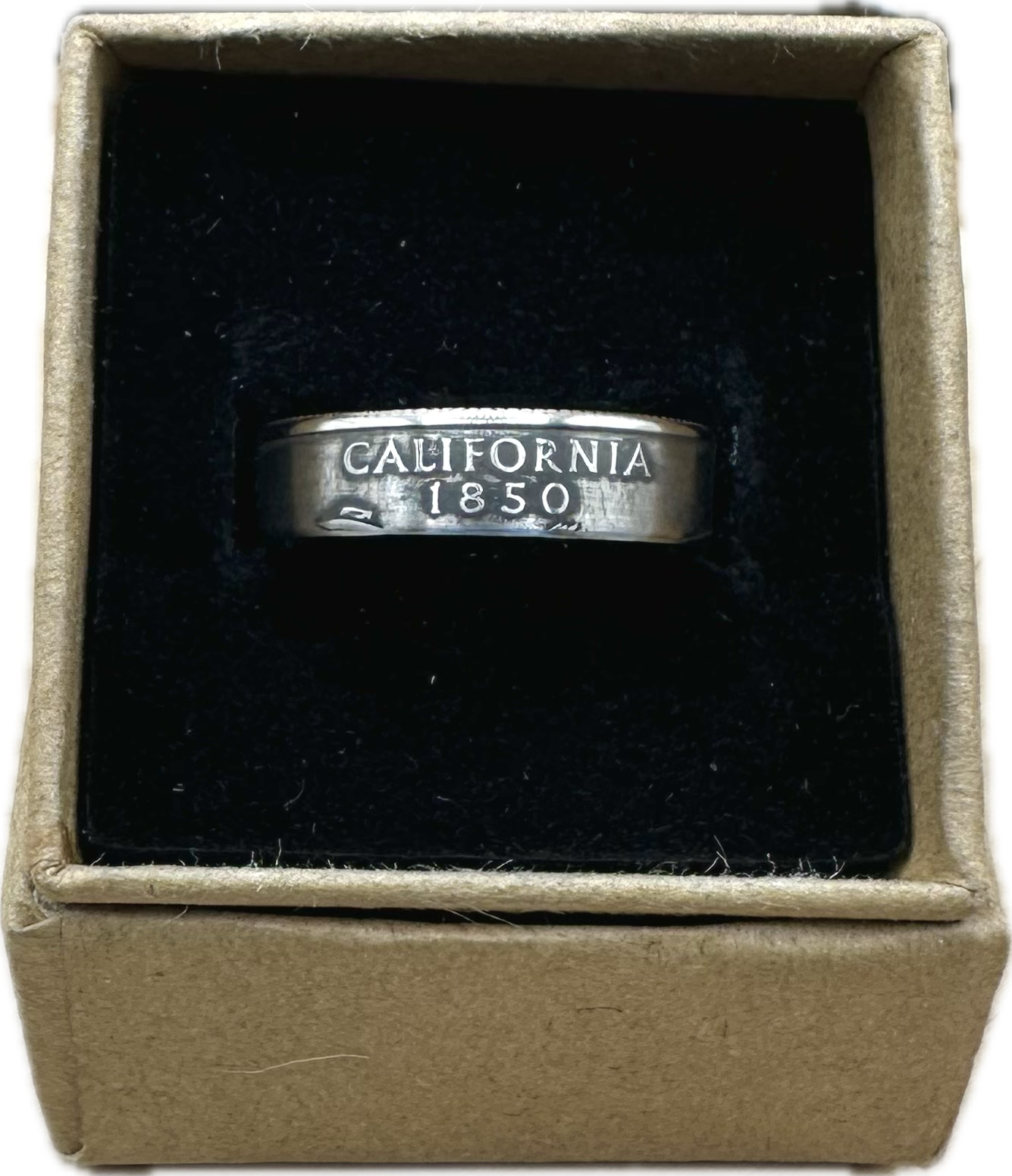 U.S. State Quarter Coin Ring featuring California in a brown kraft box on a black velvet background. - Mountainstruck Coin Jewelry