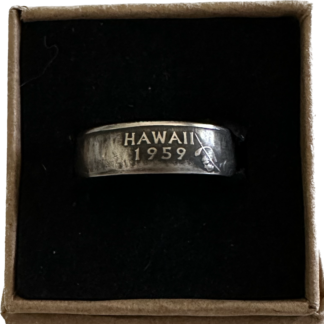 U.S. State Quarter Coin Ring featuring Hawaii patina in a brown kraft box on a black velvet background.  - Mountainstruck Coin Jewelry