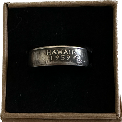 U.S. State Quarter Coin Ring featuring Hawaii patina in a brown kraft box on a black velvet background.  - Mountainstruck Coin Jewelry