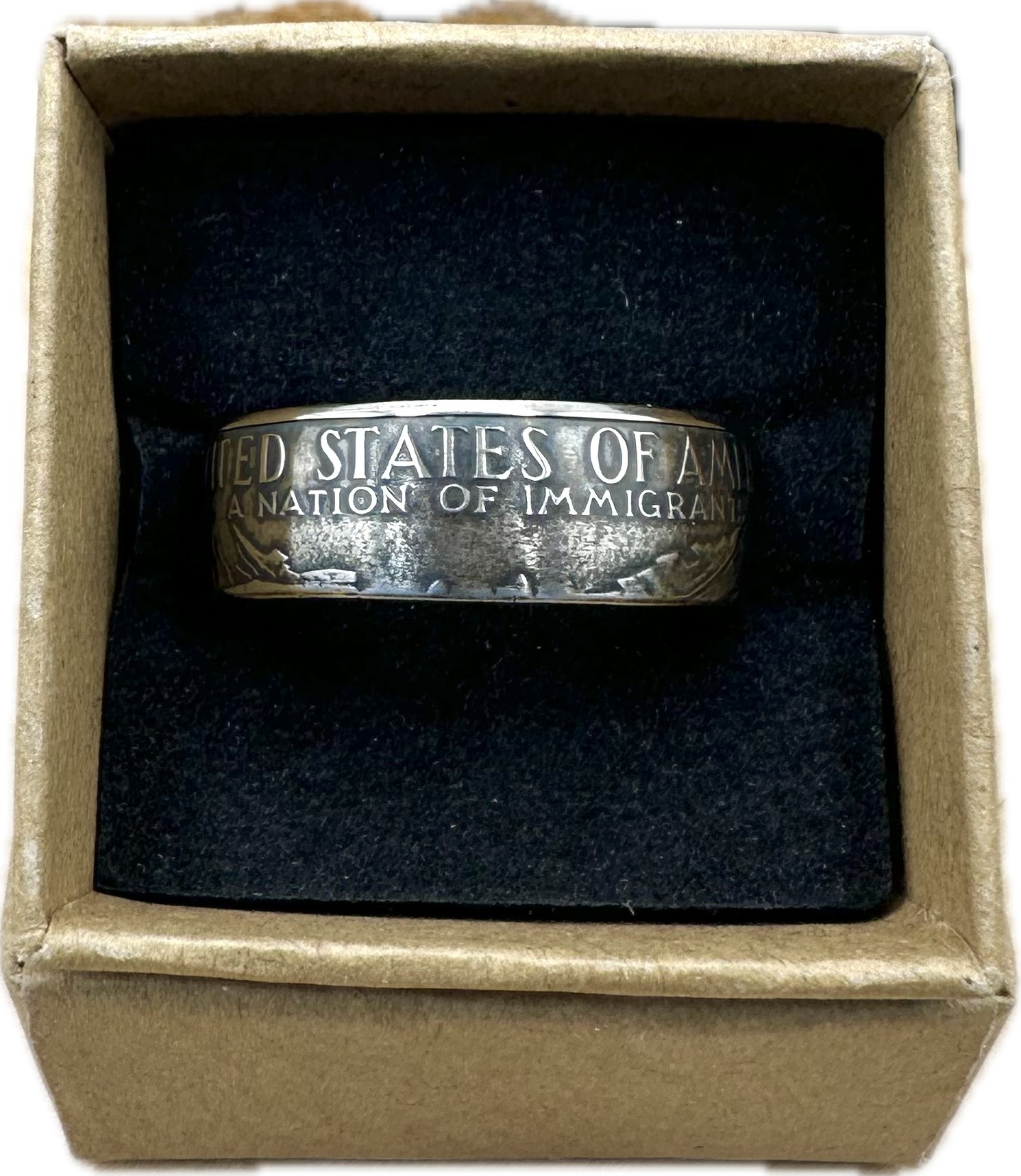 U.S. "A Nation of Immigrants" Half Dollar Coin Ring patina in a brown kraft box on a black velvet background. - Mountainstruck Coin Jewelry