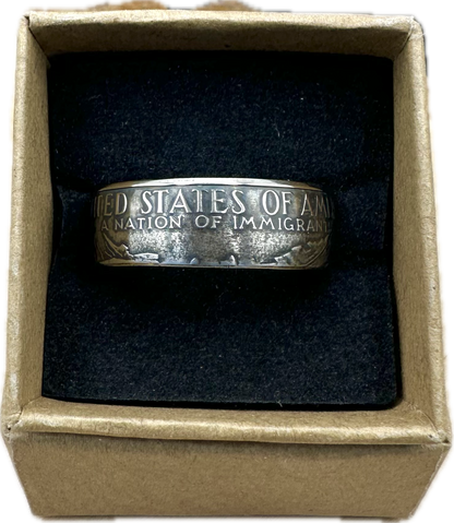 U.S. "A Nation of Immigrants" Half Dollar Coin Ring patina in a brown kraft box on a black velvet background. - Mountainstruck Coin Jewelry