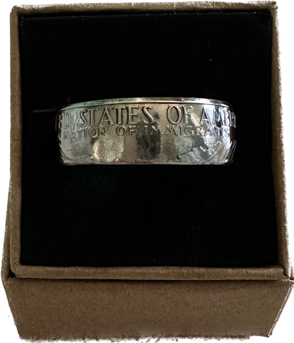 U.S. "A Nation of Immigrants" Half Dollar Coin Ring shined in a brown kraft box on a black velvet background. - Mountainstruck Coin Jewelry