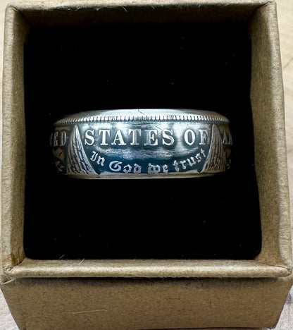 U.S. Morgan Dollar Silver Coin Ring, patina, in a brown kraft box on a black velvet background. - Mountainstruck Coin Jewelry