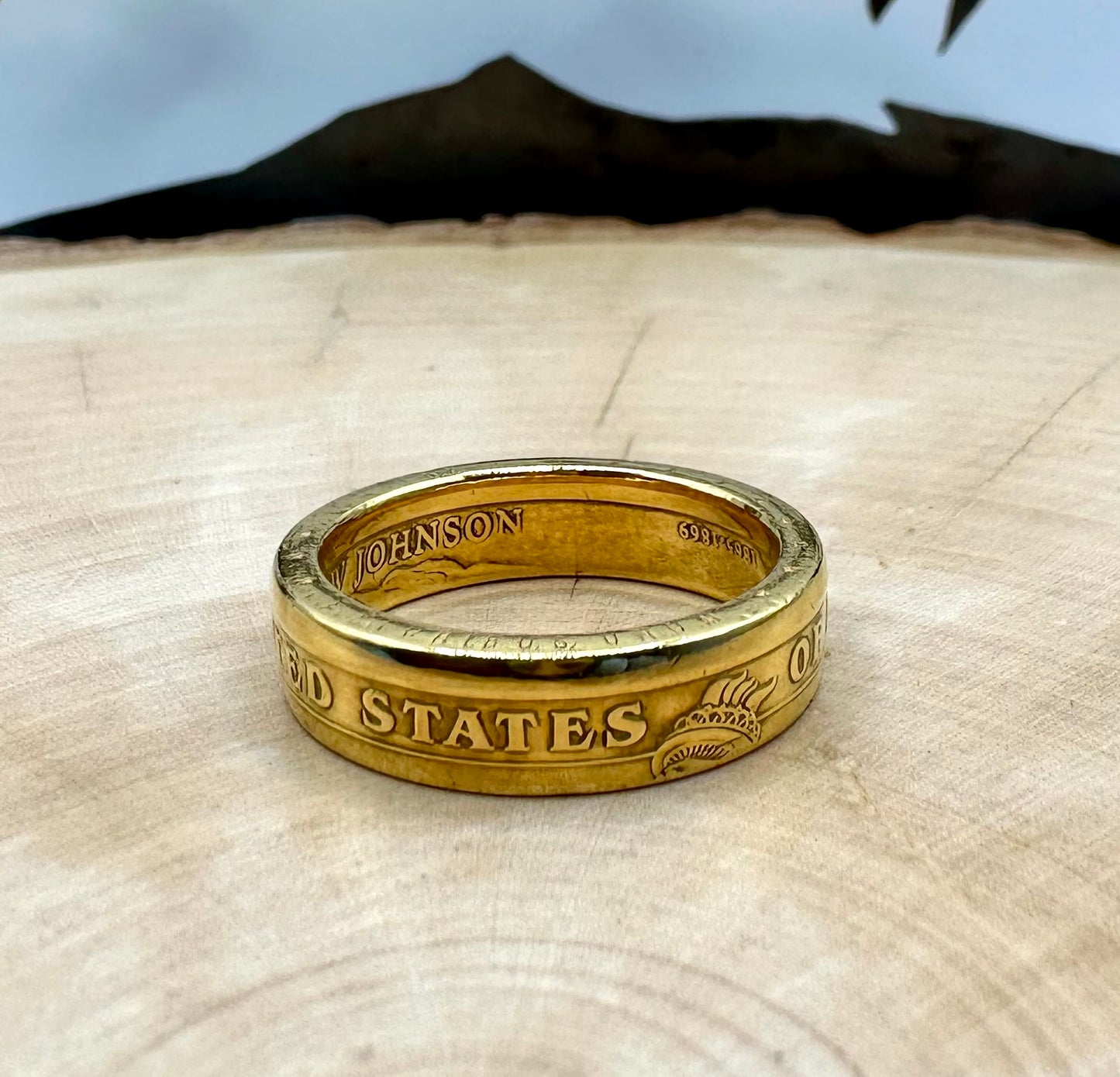 U.S. Presidential Dollar Coin Ring (Reverse) 24k Gold Plated on a light wood round with a metal mountain background. - Mountainstruck Coin Jewelry