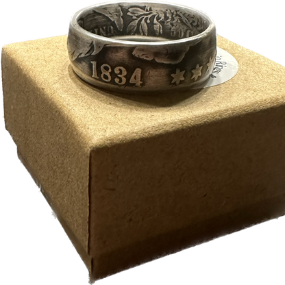U.S. (Rare) Capped Bust Liberty Silver Half Dollar Coin Ring on a brown kraft box. - Mountainstruck Coin Jewelry